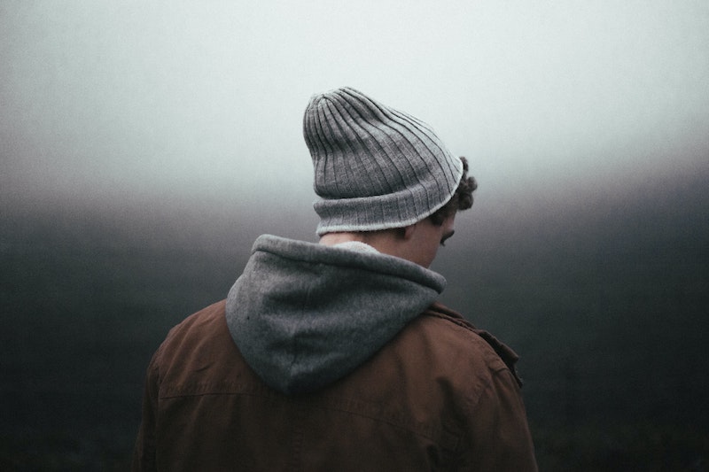 Person in warm clothing from the back of him.